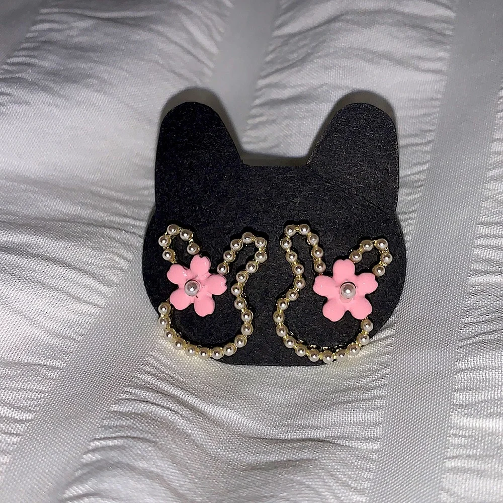 Bunny earrings with pink flower on ear